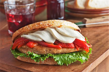 simsearch:659-06155445,k - Grilled Chicken Breast Sandwich with Roasted Red Peppers, Mozzarella Cheese and Lettuce on Grilled Tuscan Boule Bread Stock Photo - Premium Royalty-Free, Code: 659-06188425