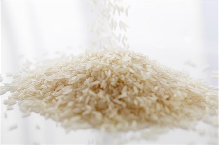 Basmati rice being poured into a heap Stock Photo - Premium Royalty-Free, Code: 659-06183814