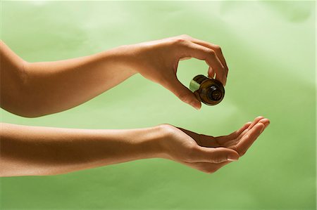 sprinkling - Woman Pouring Body Oil From Bottle into Hand Stock Photo - Premium Royalty-Free, Code: 659-06183890