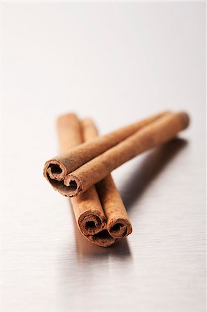 Two cinnamon sticks on a metal surface Stock Photo - Premium Royalty-Free, Code: 659-06183916