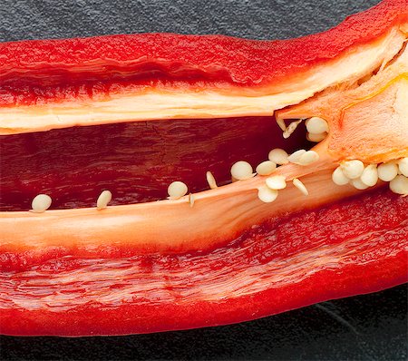 Red Pepper Sliced to Reveal Seeds and Ribs Stock Photo - Premium Royalty-Free, Code: 659-06306189