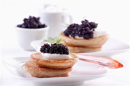 Blinis topped with sour cream and caviar Stock Photo - Premium Royalty-Free, Code: 659-06306234