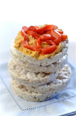 snack dish - Stack of Rice Cakes with Top Cap Topped with Hummus and Roasted Red Peppers Stock Photo - Premium Royalty-Free, Code: 659-06306261