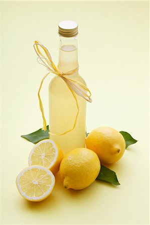 A bottle of lemonade and fresh lemons Stock Photo - Premium Royalty-Free, Code: 659-06306546