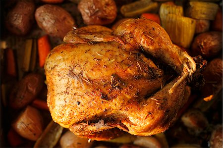 Whole Roasted Free Range Chicken with Herbs in a Pan with Organic Vegetables Stock Photo - Premium Royalty-Free, Code: 659-06306597