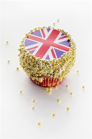 A cupcake decorated with a Union Jack and sugar balls Stock Photo - Premium Royalty-Free, Code: 659-06306623