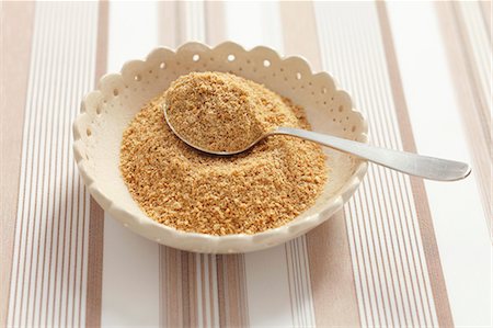 Ground flax seeds in a spoon with a spoon Stock Photo - Premium Royalty-Free, Code: 659-06306665