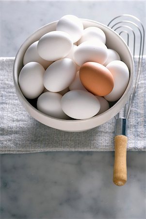 Bowl of White Eggs with One Brown Egg; Whisk Stock Photo - Premium Royalty-Free, Code: 659-06306755