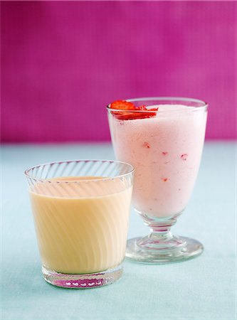 strawberry smoothie - A strawberry smoothie and a peach yogurt drink Stock Photo - Premium Royalty-Free, Code: 659-06306827