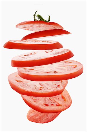 sliced - Flying tomato slices Stock Photo - Premium Royalty-Free, Code: 659-06307093