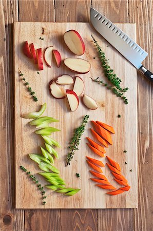 photograph of still life - Chopped Red Potato, Carrots and Celery with Thyme on a Cutting Board; From Above Stock Photo - Premium Royalty-Free, Code: 659-06307238