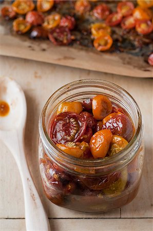 pickled - Slow Roasted Cherry Tomatoes in a Glass Jar; Sheet of Roasted Cherry Tomatoes Stock Photo - Premium Royalty-Free, Code: 659-06307232