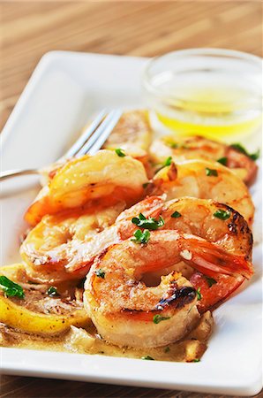 simsearch:659-08419455,k - Shrimp Scampi on a Dish with Lemon; Butter Dipping Sauce Stock Photo - Premium Royalty-Free, Code: 659-06307247