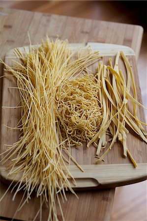 fine noodle - Various types of home-made pasta on a wooden board Stock Photo - Premium Royalty-Free, Code: 659-06307254