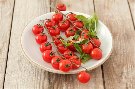 simsearch:659-01854321,k - Tomates cerises et basilic sur une plaque Photographie de stock - Premium Libres de Droits, Code: 659-06307391