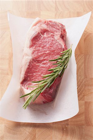 fresh ingredients grocery - Rump steak with rosemary on a piece of paper Stock Photo - Premium Royalty-Free, Code: 659-06307486