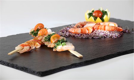 prawn finger food - Prawn kebabs and King prawns on a slate plater Stock Photo - Premium Royalty-Free, Code: 659-06307628