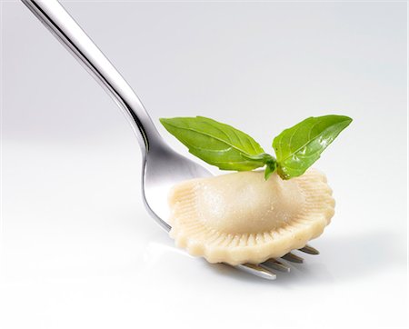 pasta - Ravioli and the basil leaf on a fork Foto de stock - Royalty Free Premium, Número: 659-06307620