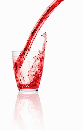 drinks, white background - A red fizzy drink being poured into a glass Stock Photo - Premium Royalty-Free, Code: 659-06307744