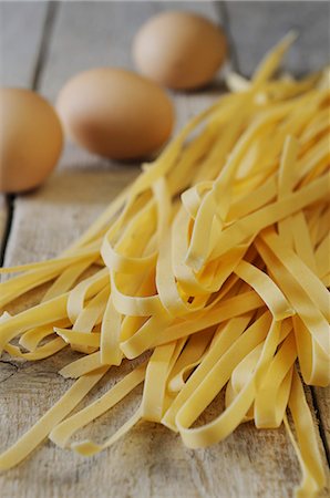 Tagliatelle and eggs on a wooden surface Stock Photo - Premium Royalty-Free, Code: 659-06307851