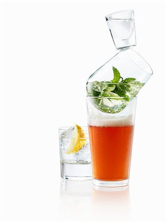 A stack of glasses with beer, mint and vodka with a gin and tonic next to it Stock Photo - Premium Royalty-Free, Code: 659-06372350