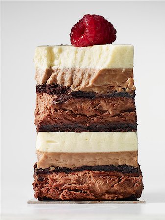 A slice of layered chocolate cake topped with a raspberry Foto de stock - Sin royalties Premium, Código: 659-06372366