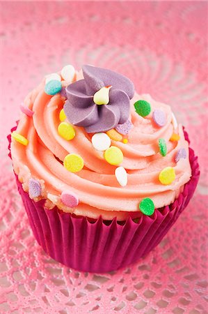 pink cupcake flowers - A cupcake decorated with buttercream, sugar sprinkles and a sugar flower Stock Photo - Premium Royalty-Free, Code: 659-06372466