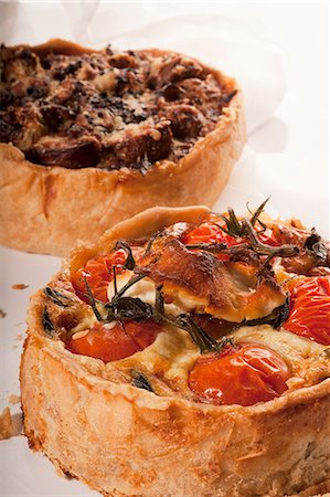 Two Deep Dish Pizzas; Mushroom and Cheese and Tomato and Cheese Stock Photo - Premium Royalty-Free, Code: 659-06372838