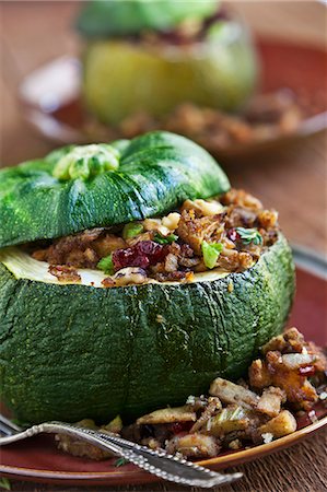 stuffing (seasoned bread crumbs) - Acorn Squash Stuffed with Dried Cranberry, Apple Cinnamon and Corn Muffin Stuffing Stock Photo - Premium Royalty-Free, Code: 659-06373124