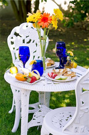 strawberries apple - Outdoor Table Set with a Belgian Waffle Breakfast; Tall Flowers in a Vase on Table Stock Photo - Premium Royalty-Free, Code: 659-06373249