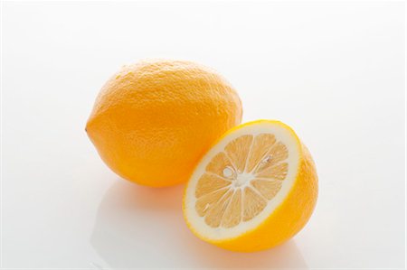 Lemons, two whole and one half Stock Photo - Premium Royalty-Free, Code: 659-06373491