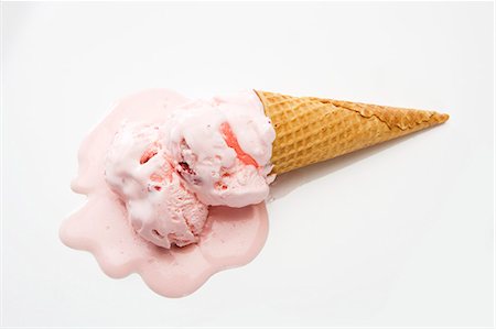 Strawberry Ice Cream Cone Melting on a White Background Stock Photo - Premium Royalty-Free, Code: 659-06373501