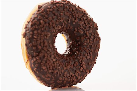 A doughnut with chocolate glaze and chocolate sprinkles Stock Photo - Premium Royalty-Free, Code: 659-06373549