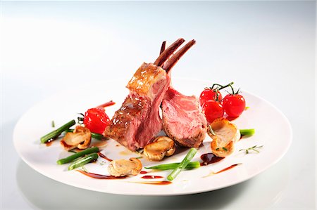 Lamb crown with mushrooms, beans and cherry tomatoes Stock Photo - Premium Royalty-Free, Code: 659-06373768