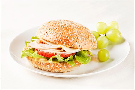 sesame bread - Turkey Sandwich on a Sesame Seed Bun with Green Grapes Stock Photo - Premium Royalty-Free, Code: 659-06373815