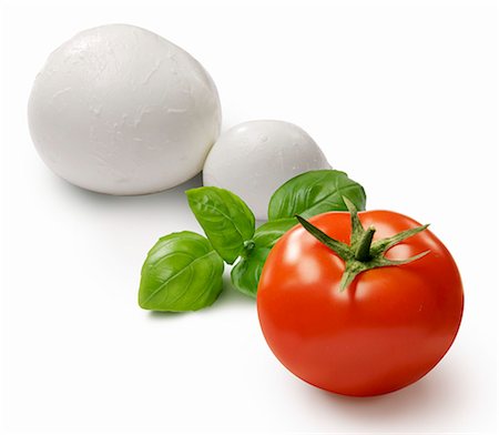 symbolic image - A tomato, basil and mozzarella Stock Photo - Premium Royalty-Free, Code: 659-06373822
