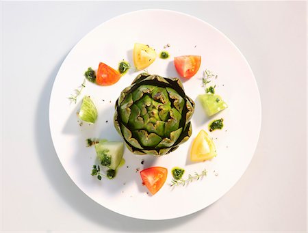 food plate isolated - An artichoke with tomatoes and pesto Stock Photo - Premium Royalty-Free, Code: 659-06373891