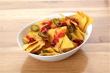 Tortilla chips with barbecue sauce and jalapeños Stock Photo - Premium Royalty-Free, Code: 659-06494017