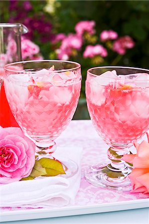 food tray - Two glasses of rose syrup with ice cubes and rose petals on a tray Stock Photo - Premium Royalty-Free, Code: 659-06494290