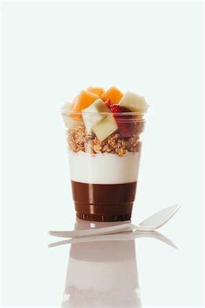 Chocolate and Plain Yogurt Topped with Granola and Fruit; In a Plastic Cup; Plastic Spoon Stock Photo - Premium Royalty-Free, Code: 659-06494602