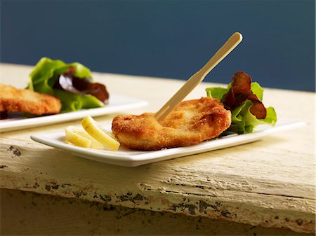 An escalope with a mixed leaf salad and a wooden fork Foto de stock - Sin royalties Premium, Código: 659-06495057