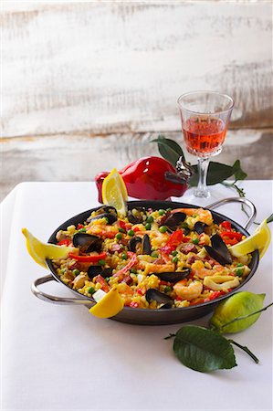 A pan of mixed paella and a glass of wine Stock Photo - Premium Royalty-Free, Code: 659-06495075