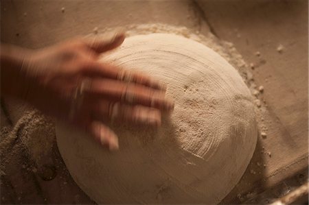 simsearch:659-06495090,k - A hand sprinkling an unbaked loaf with flour Stock Photo - Premium Royalty-Free, Code: 659-06495085