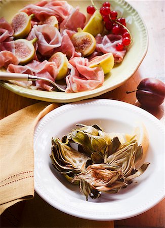 exotic cuisine - Roasted Artichokes in a Bowl; Prosciutto and Figs in a Bowl Stock Photo - Premium Royalty-Free, Code: 659-06495105