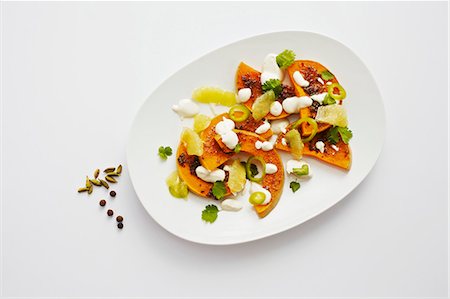 simsearch:659-06186959,k - Oven-roasted pumpkin with cardamom, limes and tahina yoghurt Photographie de stock - Premium Libres de Droits, Code: 659-06495472