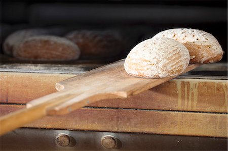 simsearch:659-06495523,k - Wheat-rye bread being removed from an oven Stock Photo - Premium Royalty-Free, Code: 659-06495521