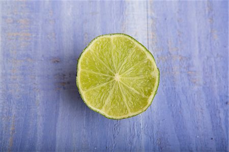 simsearch:659-06494077,k - Half a lime on a blue surface Photographie de stock - Premium Libres de Droits, Code: 659-06495618