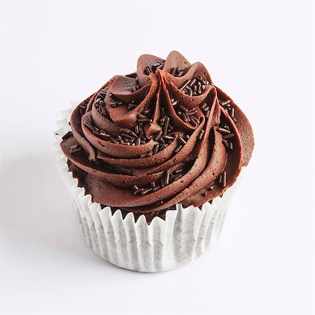 sponge mixture - A chocolate cupcake on a white surface Stock Photo - Premium Royalty-Free, Code: 659-06495692