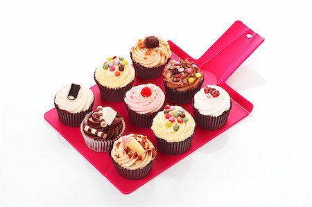 surtido - Various cupcakes on a tray Foto de stock - Sin royalties Premium, Código: 659-06493851