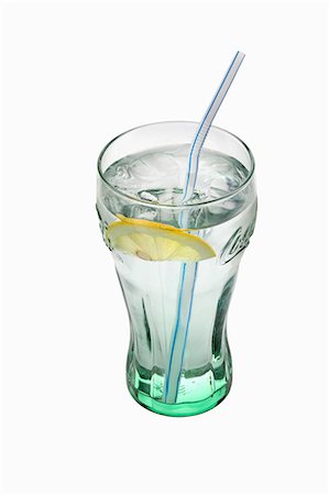 fruit dropping into water - A glass of water with a slice of lemon and a straw Stock Photo - Premium Royalty-Free, Code: 659-06493958